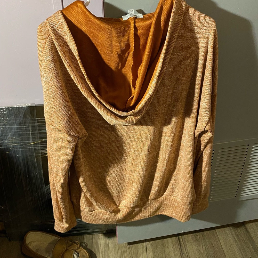It’s yellow mustard it has a hoodie and pocket  it’s from sister of the style